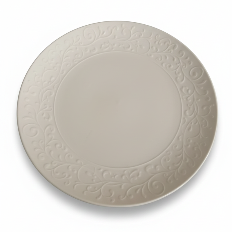 plato de porcelana blanco con un borde decorativo en relieve.